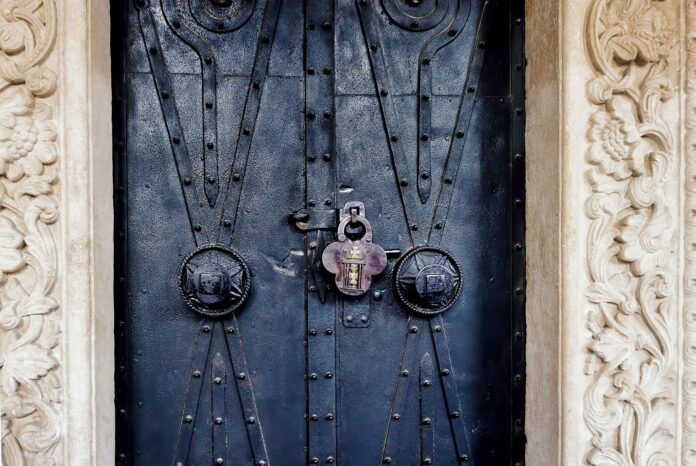 Old ornate church door with a lock