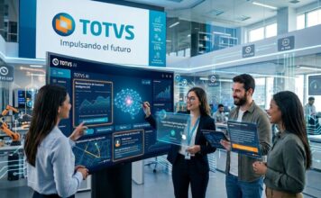 TOTVS impulsa bases estratégicas para acelerar el éxito de la IA en América Latina Una imagen corporativa futurista de un equipo de TOTVS interactuando con paneles de datos y pantallas flotantes transparentes. En el centro, una pantalla grande de 'TOTVS AI' muestra gráficos e información sobre 'Recomendación de inventario Inteligente (RI)', 'TOTVS ERP' y 'Big Data'. Cuatro empleados usan dispositivos flotantes para visualizar planes de optimización de la cadena de suministro. Al fondo, un letrero de 'TOTVS' dice 'Impulsando el futuro' y muestra estadísticas de crecimiento. La escena está llena de símbolos tecnológicos y un brazo robótico en una mesa.