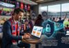 BeyondTrust: cómo proteger el trabajo remoto durante la temporada deportiva y los viajes de negocios Ilustración conceptual en un bar deportivo donde un ejecutivo con traje y bufanda de aficionado trabaja en su laptop frente a una barra. Al fondo, una pantalla gigante muestra un partido de fútbol en un estadio lleno de seguidores. Sobre la computadora flotan gráficos holográficos de ciberseguridad que incluyen la silueta de un hacker encapuchado con los letreros "Credenciales expuestas" y "Ataque de red", los cuales son bloqueados por un escudo azul brillante con un candado que lleva la marca BeyondTrust Modern PAM.