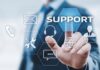 Vulnerabilidades y ransomware elevan el riesgo operativo para industrias estratégicas, advierte Kaseya Ilustración digital en la que un profesional de traje interactúa con una interfaz futurista de hexágonos flotantes. Su dedo índice presiona el botón azul con la palabra "SUPPORT", rodeado de iconos tecnológicos como un sobre de correo, un teléfono, herramientas de mantenimiento, unos auriculares con micrófono, un globo terráqueo, un globo de texto y la silueta de una persona.