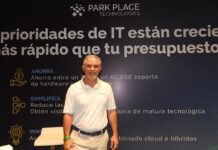 El salvavidas del centro de datos corporativo se llama Park Place y redefine la inversión tecnológica Fotografía en plano medio de Rogelio Moncada, Director Comercial para North Latam en Park Place Technologies, vistiendo camisa blanca tipo polo corporativa, posando sonriente frente a un muro publicitario con la frase "Las prioridades de IT están creciendo más rápido que tu presupuesto".